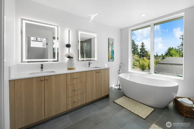 a bathroom with a tub sink and mirror