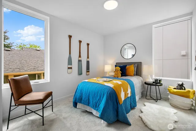 a bedroom with furniture and a large window