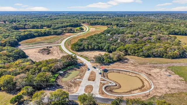 an aerial view of a house with a swimming pool and outdoor space