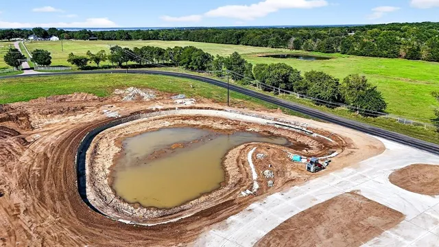 a view of a swimming pool with a yard