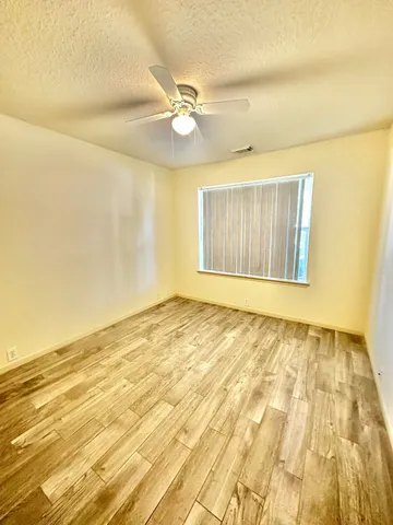 a spacious bathroom with a double vanity sink toilet mirror and bathtub