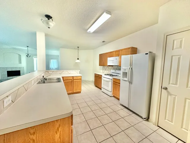 a kitchen with refrigerator cabinets and white appliances