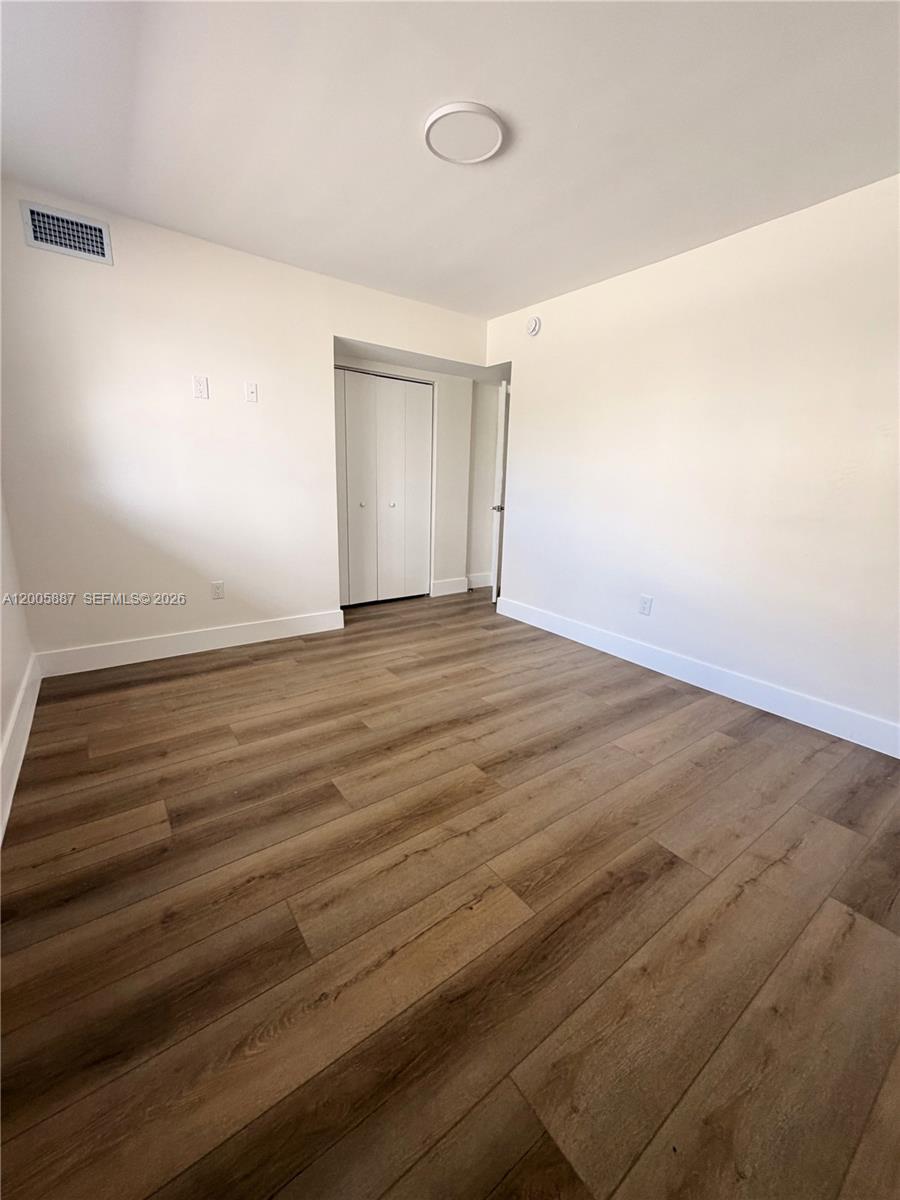 1904 Southwest 17th Avenue, Unit 8 Miami, FL 33145 - Photo 7 of 11 wooden floor in an empty room