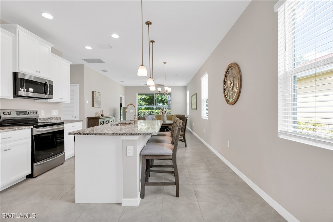 2125 Summersweet Drive Alva, FL 33920 - Photo 12 of 32 a kitchen with a refrigerator and a stove top oven
