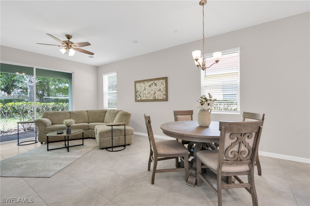 2125 Summersweet Drive Alva, FL 33920 - Photo 16 of 32 a dining room with furniture a chandelier and a rug