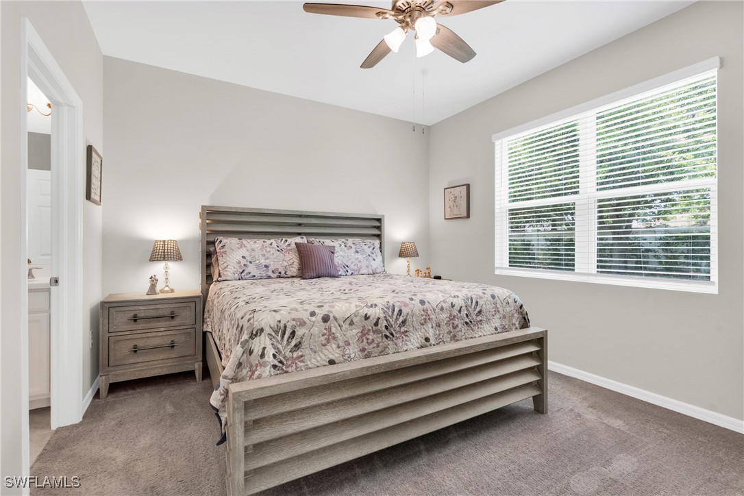 2125 Summersweet Drive Alva, FL 33920 - Photo 19 of 32 a bedroom with a bed and a chandelier