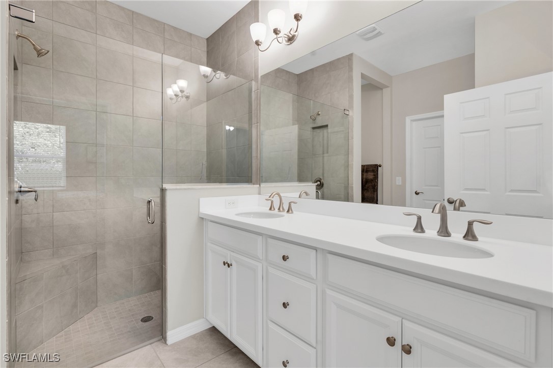 2125 Summersweet Drive Alva, FL 33920 - Photo 21 of 32 a bathroom with a double vanity sink mirror and shower