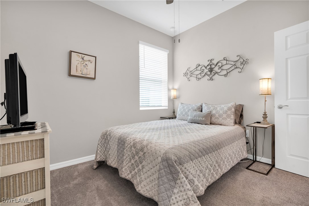 2125 Summersweet Drive Alva, FL 33920 - Photo 25 of 32 a bedroom with a large bed and a flat tv screen on dresser