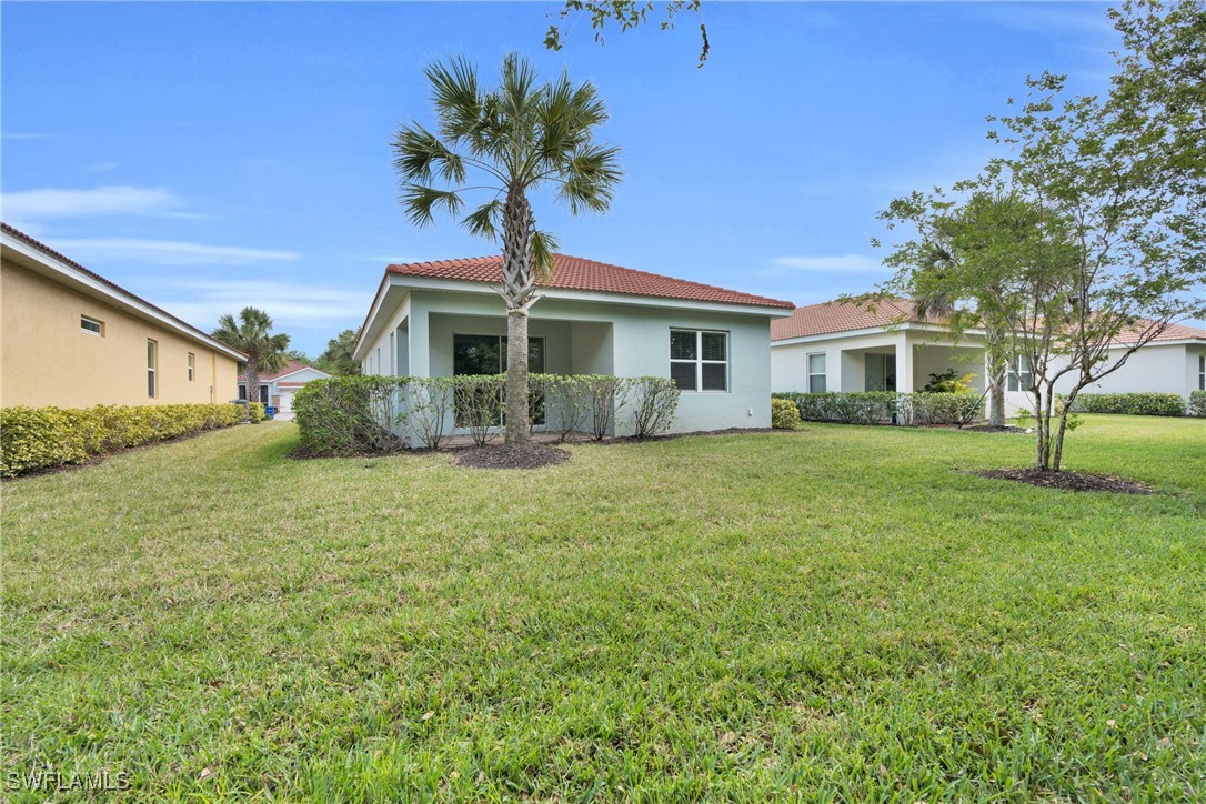 2125 Summersweet Drive Alva, FL 33920 - Photo 32 of 32 a front view of a house with a garden and trees