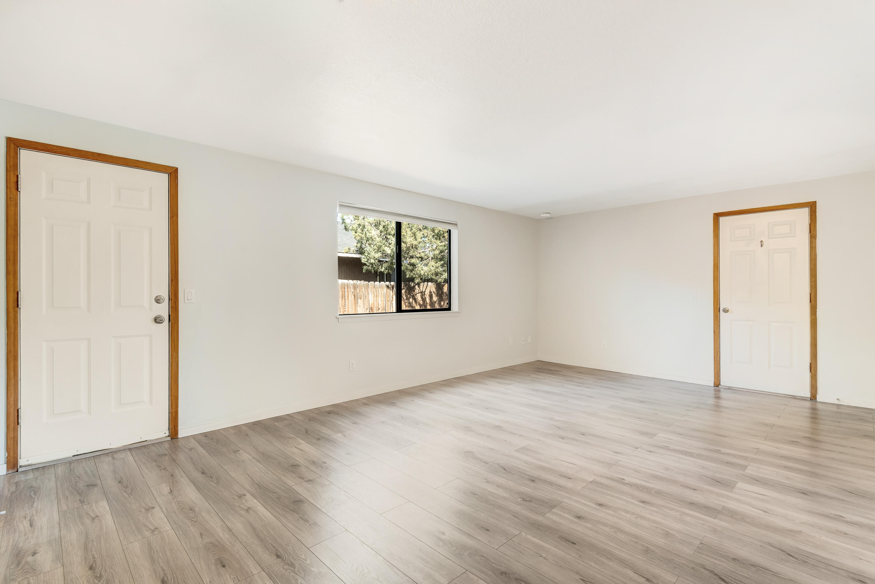 1916 Northeast Wichita Way Bend, OR 97701 - Photo 8 of 38 an empty room with wooden floor and windows