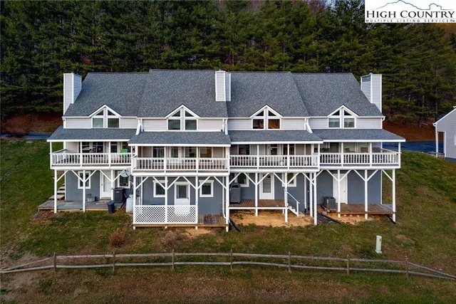 an aerial view of a house with swimming pool and porch