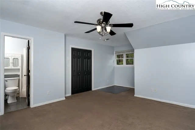 a view of a livingroom with a ceiling fan and window