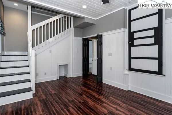 a view of entryway with wooden floor and stairs