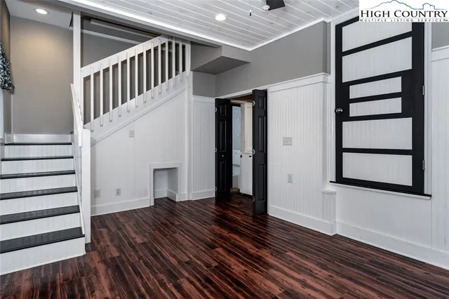 a view of entryway with wooden floor and stairs
