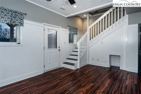 a view of entryway and hall with wooden floor