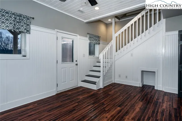 a view of entryway and hall with wooden floor