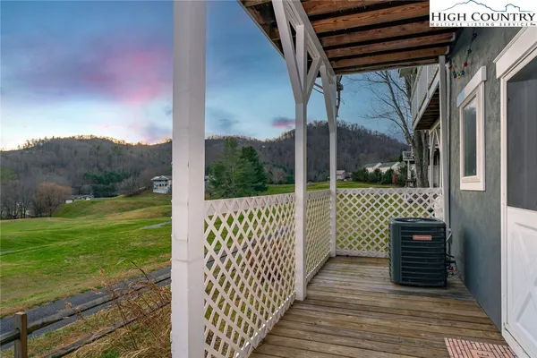 a view of a deck with wooden floor and wooden fence