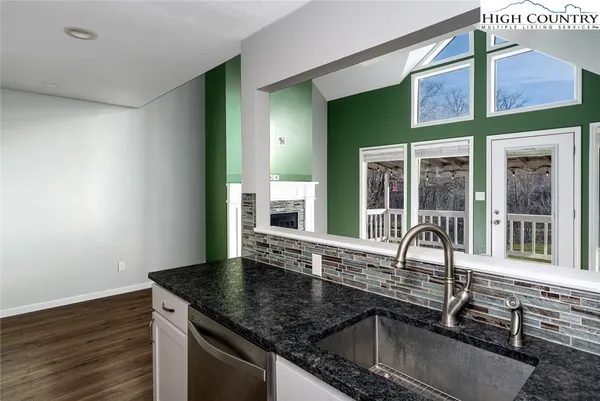 a kitchen with granite countertop a sink and a window
