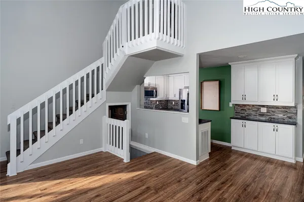 a view of entryway and hall with wooden floor