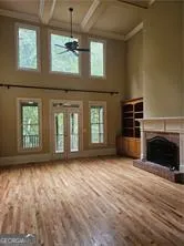 a view of an empty room with a fireplace and a window