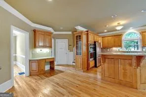 a open kitchen with granite countertop a refrigerator and a sink