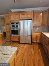 a kitchen with granite countertop a refrigerator and a sink