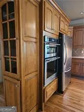 a metallic refrigerator freezer sitting in a kitchen