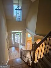 a view of entryway and hall with wooden floor