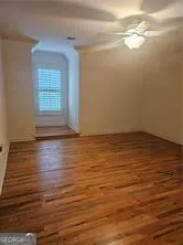 a view of room with window and wooden floor
