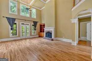 a view of an empty room with a window and fireplace