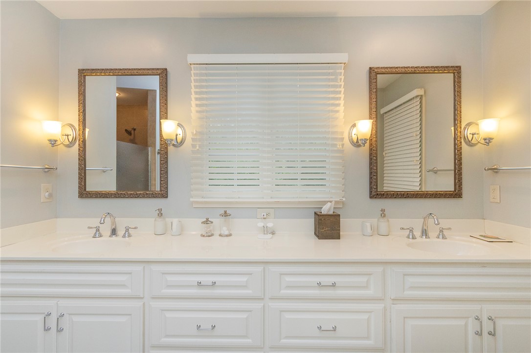 203 Oak Hollow Pendleton, SC 29670 - Photo 24 of 50 Dual vanities and ornate mirrors elevate this bright, functional bathroom space.