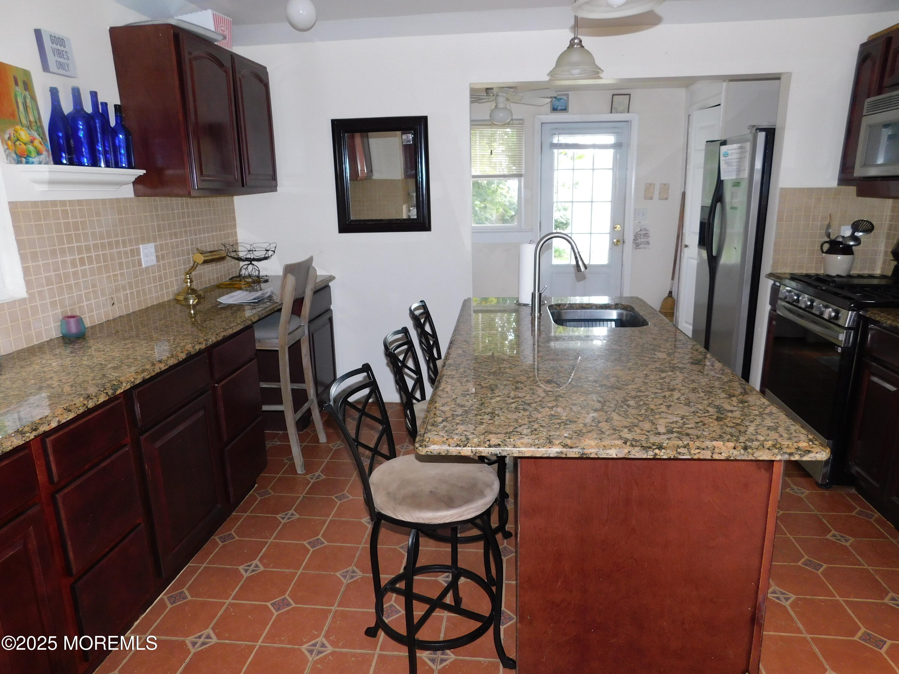 319 Jersey Avenue Spring Lake, NJ 07762 - Photo 11 of 21 a kitchen with stainless steel appliances granite countertop a sink stove and cabinets