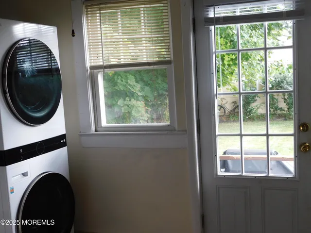 a view of a bedroom with a large window and a washer