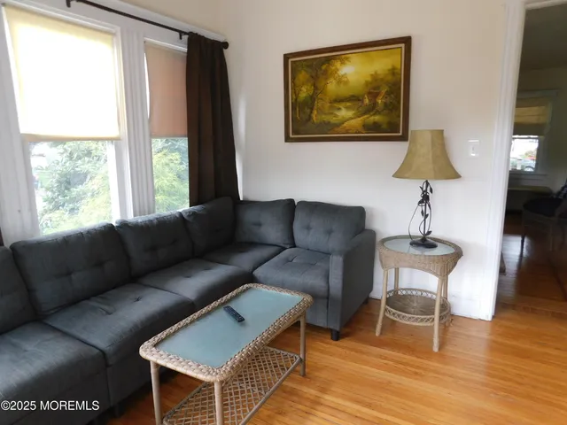 a living room with furniture a window and a lamp