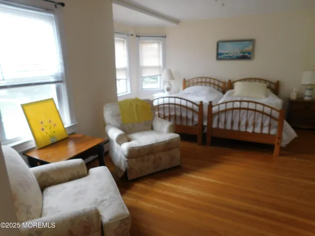 a bedroom with furniture and a window
