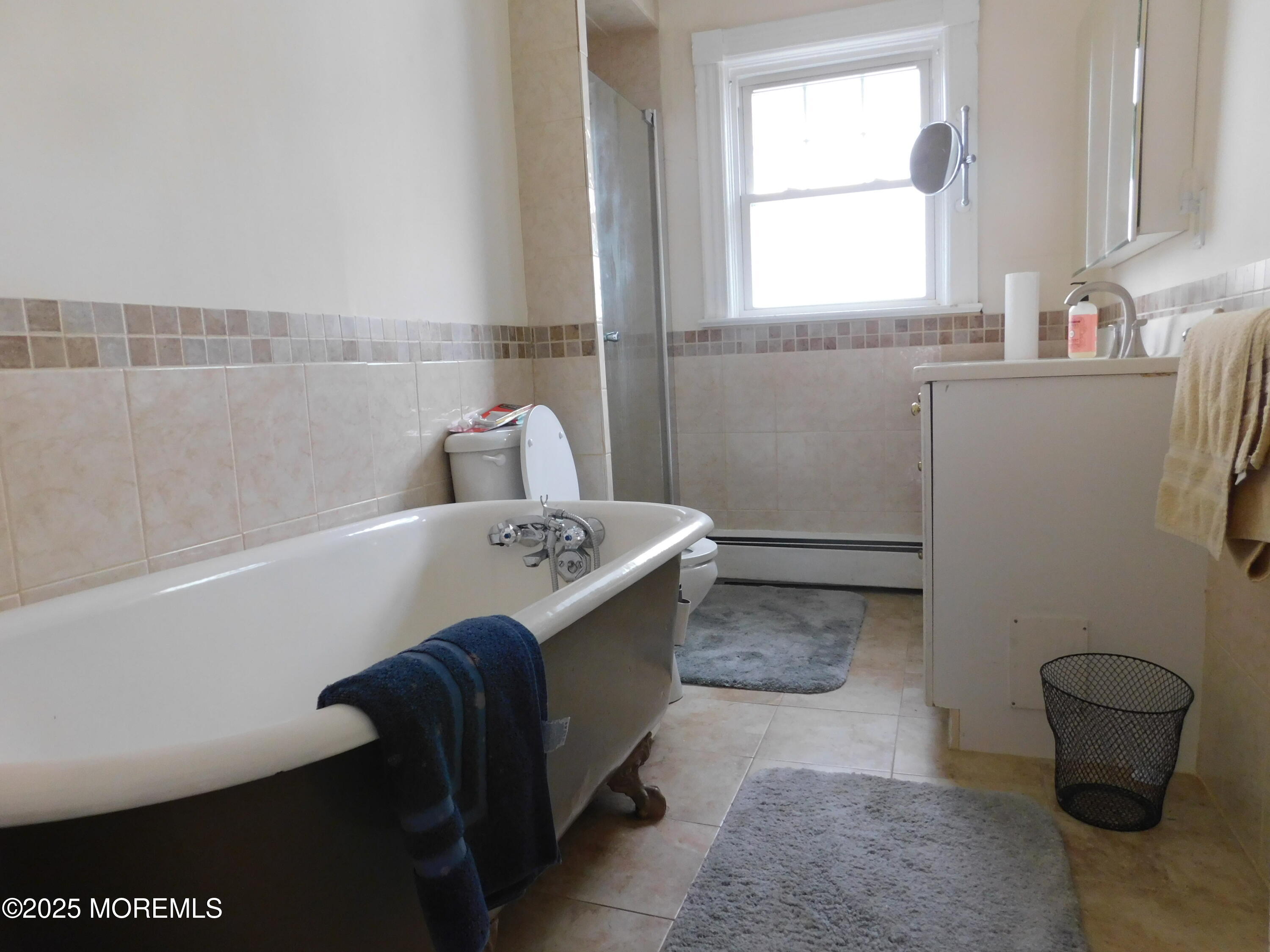 319 Jersey Avenue Spring Lake, NJ 07762 - Photo 16 of 21 a room with a sink a toilet and a window