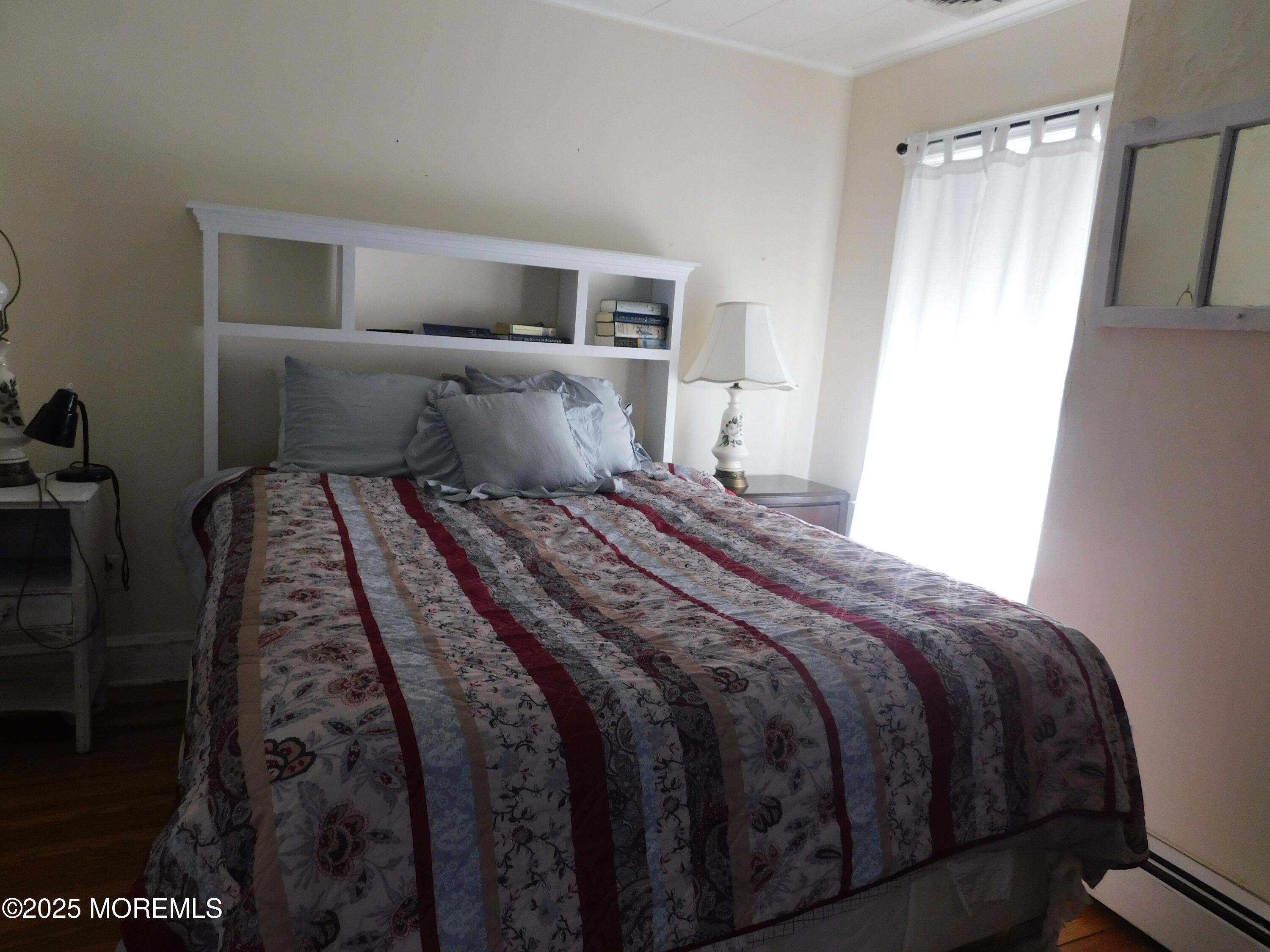 319 Jersey Avenue Spring Lake, NJ 07762 - Photo 18 of 21 a bedroom with a bed and wooden floor