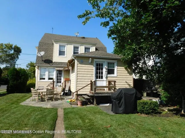 a view of a house with a yard porch and sitting area