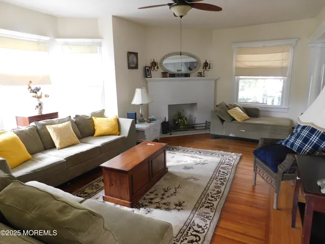 a living room with furniture fireplace and a window