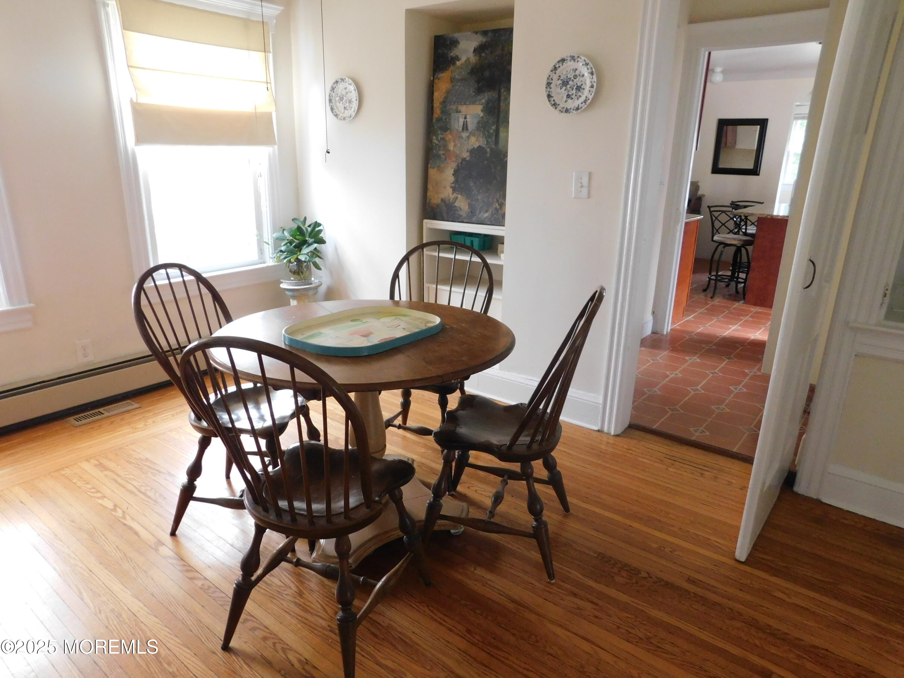 319 Jersey Avenue Spring Lake, NJ 07762 - Photo 9 of 21 a view of a dining room with furniture and wooden floor