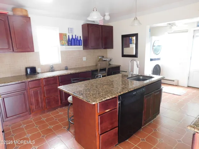 a kitchen with granite countertop a sink and a stove