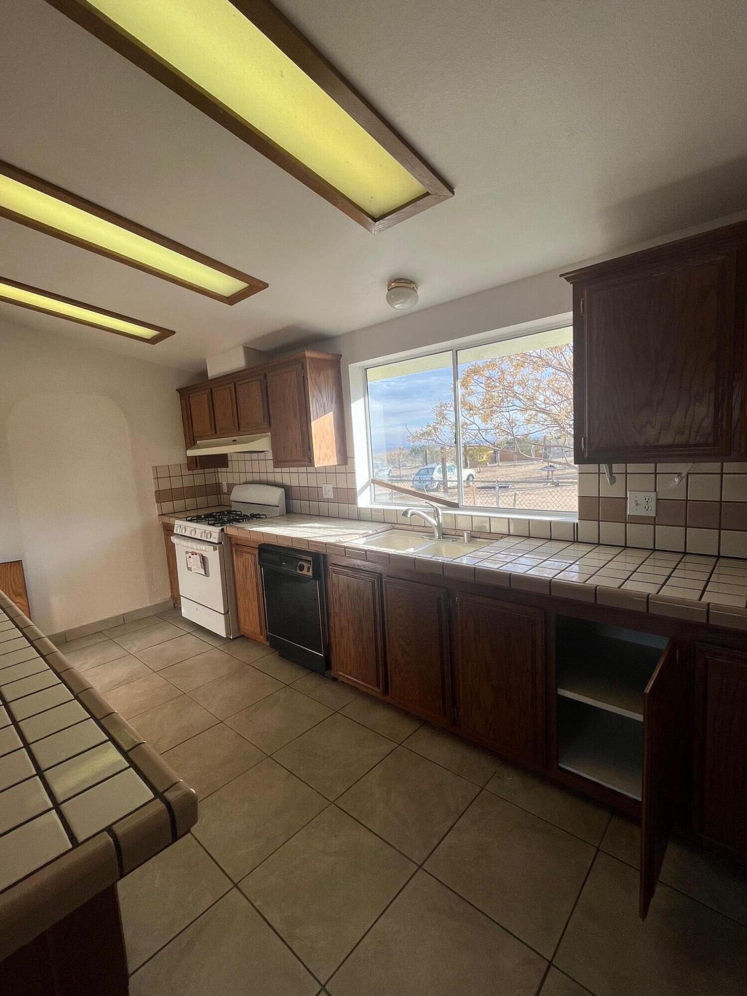 21925 Fort Tejon Road Llano, CA 93544 - Photo 8 of 10 a kitchen with stainless steel appliances kitchen island granite countertop a sink and cabinets
