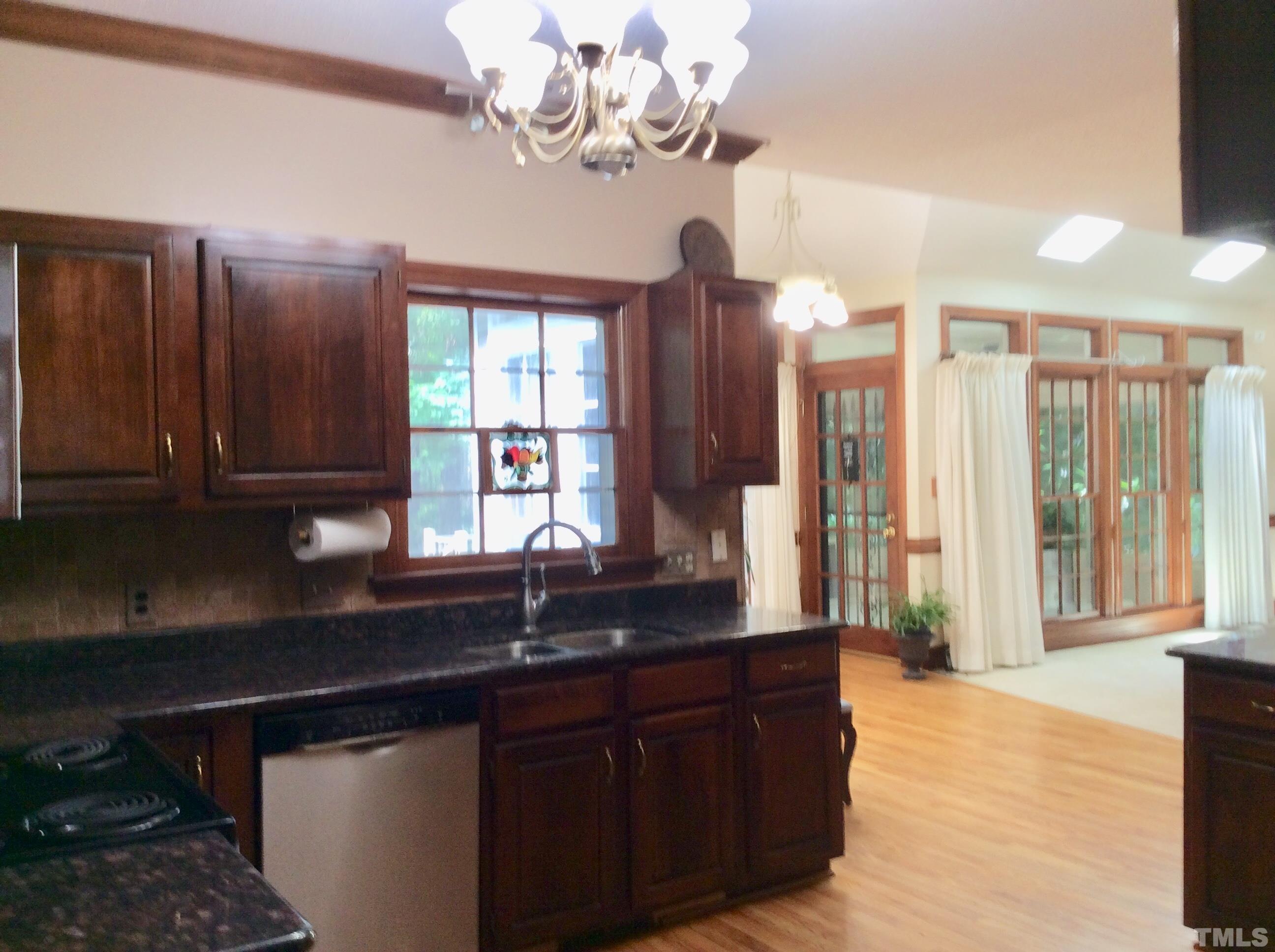 12105 Warwickshire Way Raleigh, NC 27613 - Photo 17 of 44 a kitchen with a sink and chandelier