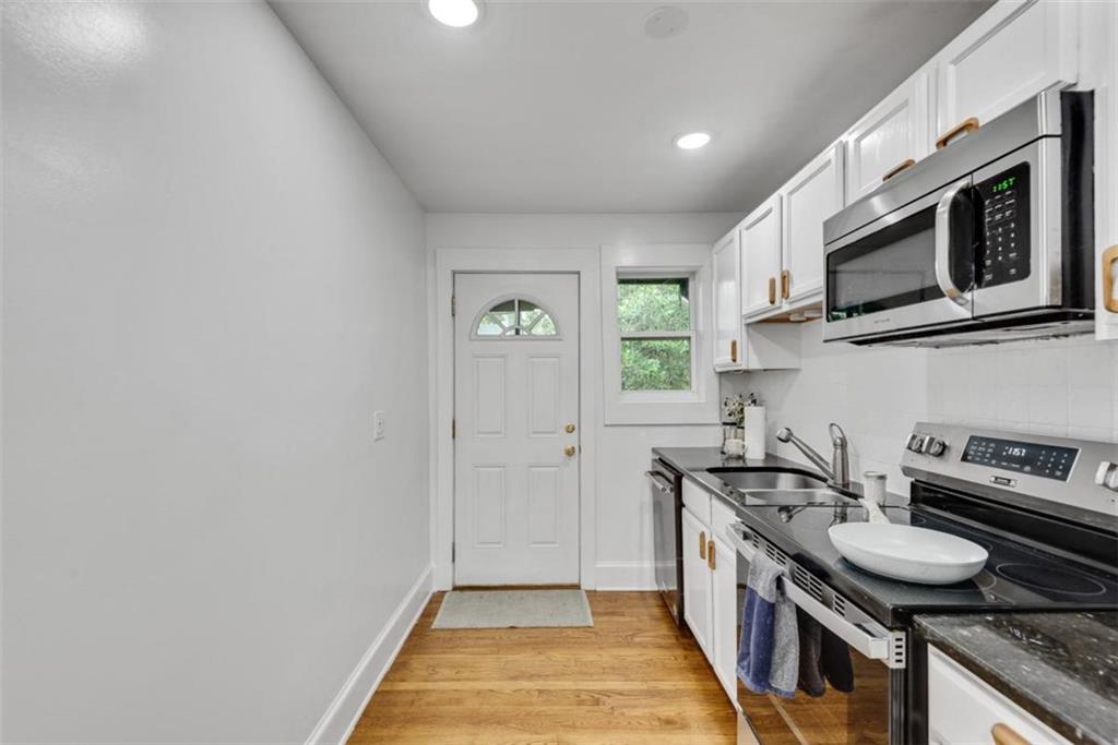 351 Cherokee Avenue Southeast, Unit 8 Atlanta, GA 30312 - Photo 11 of 28 a kitchen with stainless steel appliances granite countertop a stove and a sink