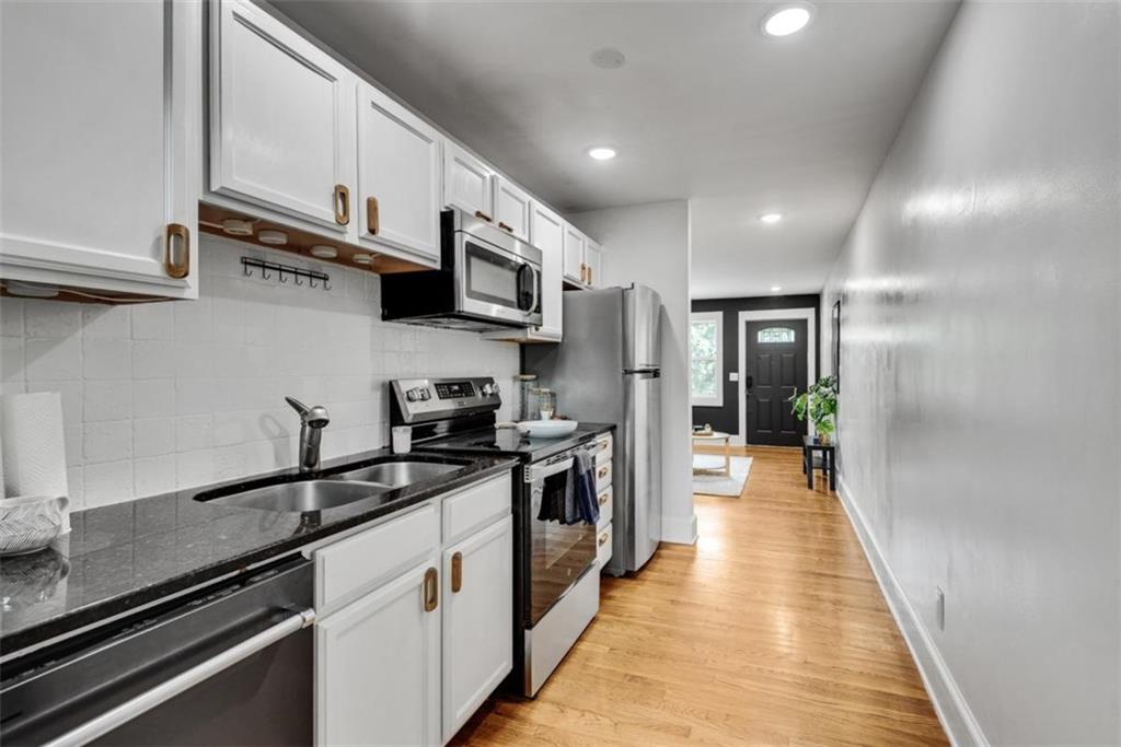 351 Cherokee Avenue Southeast, Unit 8 Atlanta, GA 30312 - Photo 12 of 28 a kitchen with stainless steel appliances granite countertop lots of counter top space