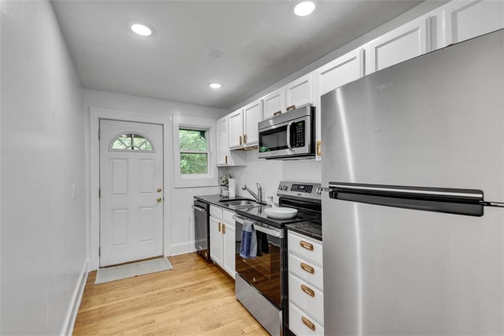 351 Cherokee Avenue Southeast, Unit 8 Atlanta, GA 30312 - Photo 13 of 28 a kitchen with stainless steel appliances a refrigerator stove and microwave