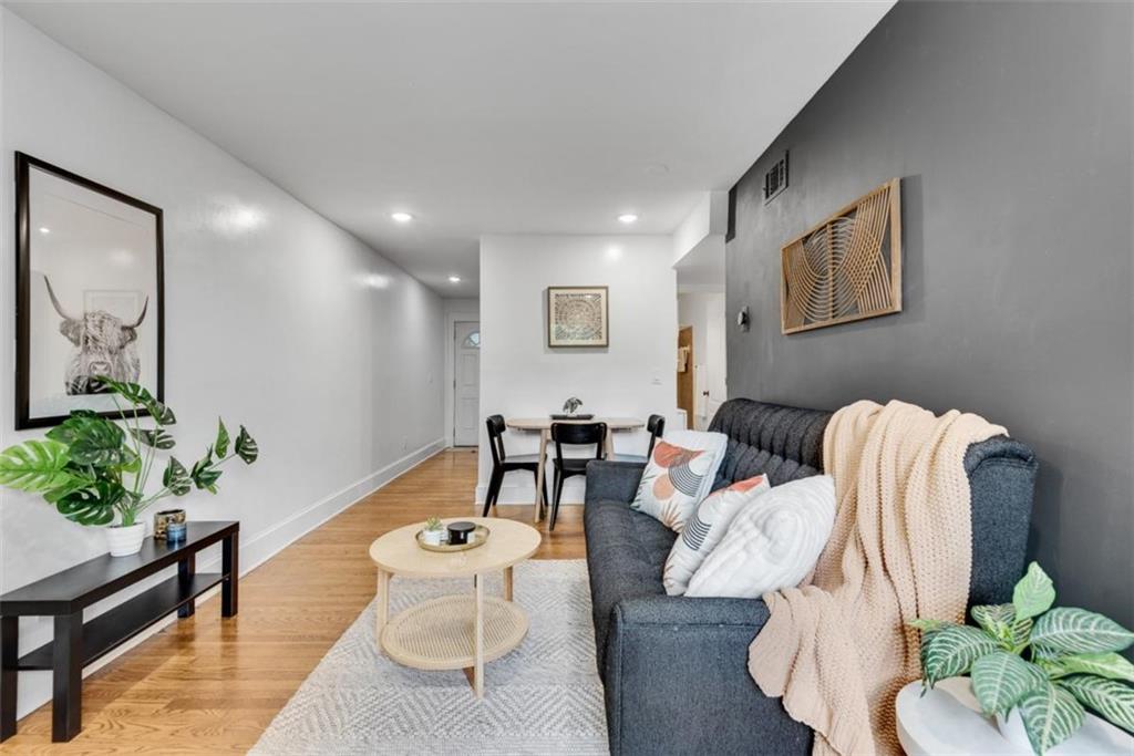351 Cherokee Avenue Southeast, Unit 8 Atlanta, GA 30312 - Photo 4 of 28 a living room with furniture and a potted plant