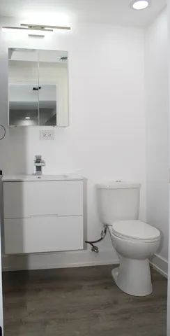 a bathroom with a toilet and a mirror