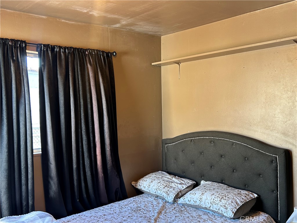 2011 East Elizabeth Street Compton, CA 90221 - Photo 13 of 19 a bedroom with a bed and a window
