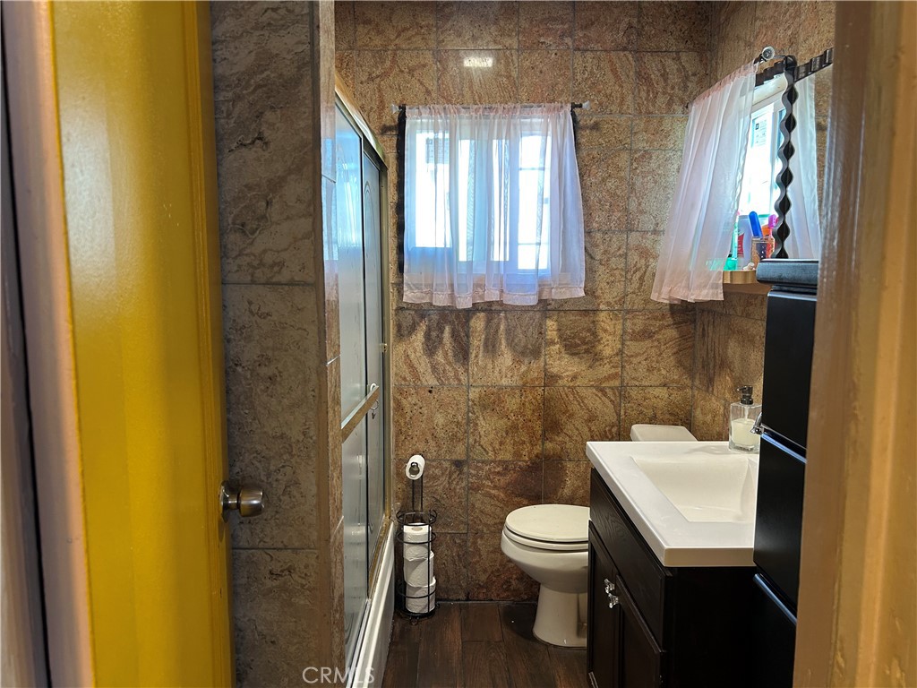 2011 East Elizabeth Street Compton, CA 90221 - Photo 16 of 19 a bathroom with a toilet a sink and mirror